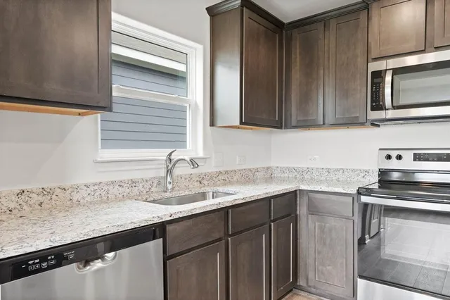 a kitchen with a sink stove and microwave