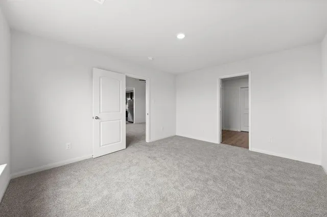 a view of an empty room and a window