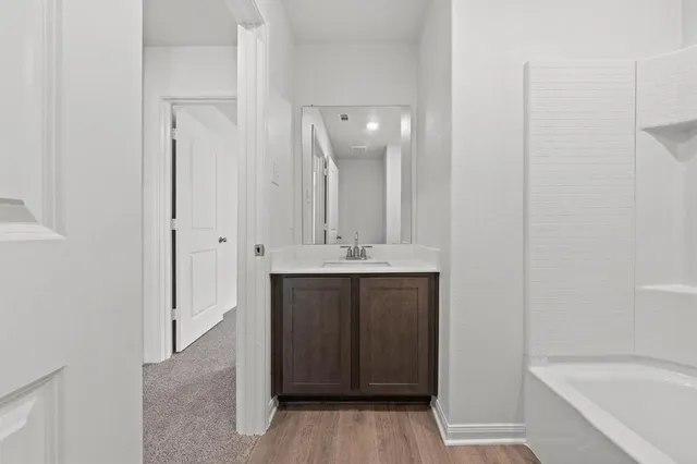 a bathroom with a sink a mirror and a bathtub