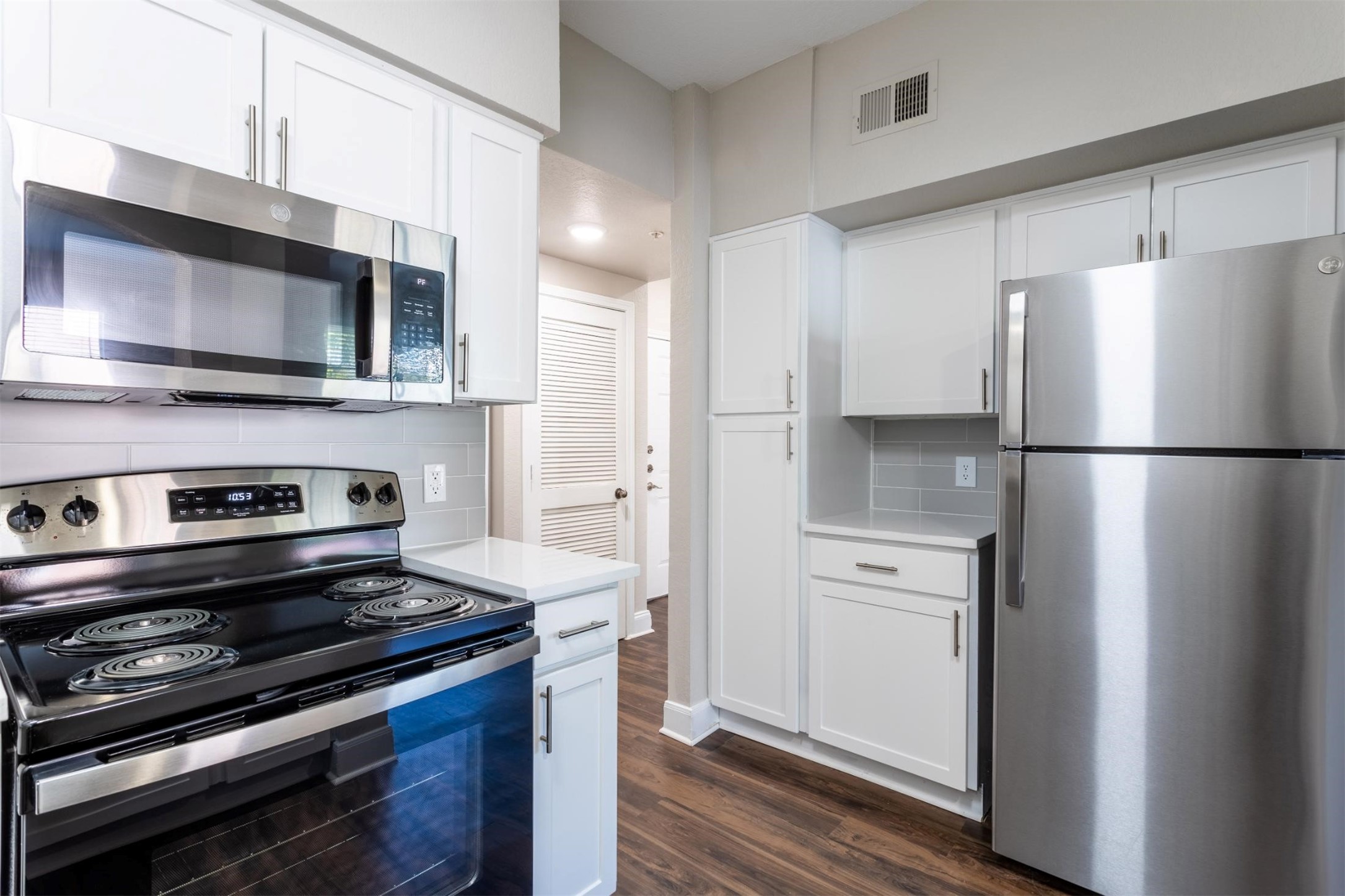 320 Jackson Hill Street, Unit 2 Houston, TX 77007 - Photo 5 of 18 a kitchen with stainless steel appliances and wooden cabinets