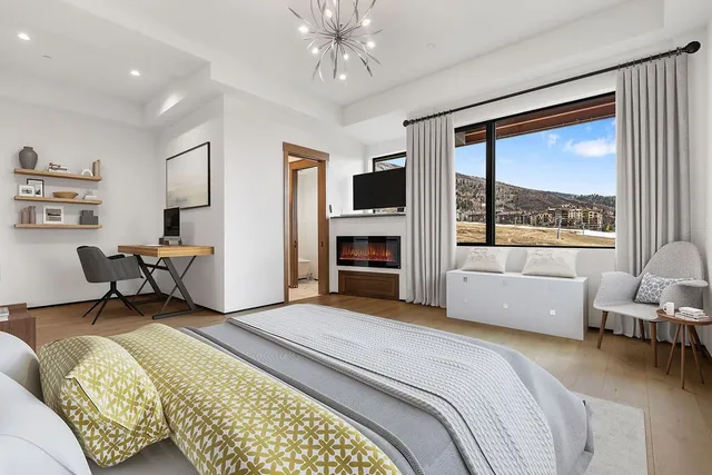 a spacious bedroom with a bed and a large window