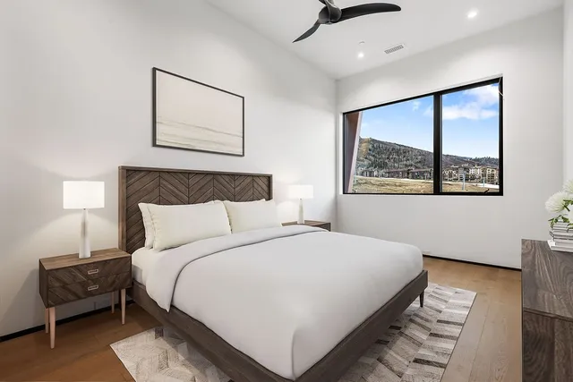 a bedroom with a bed and a painting on the wall