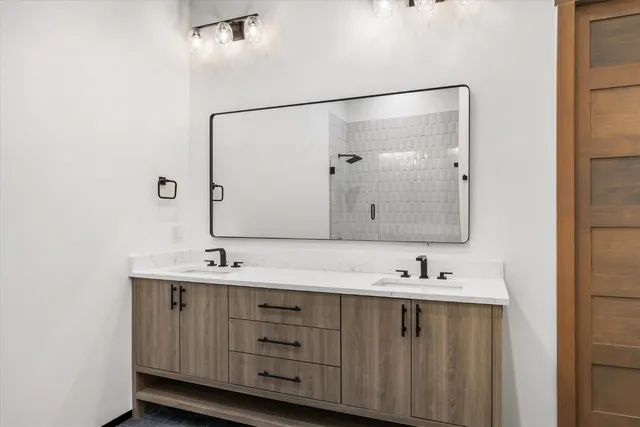 a bathroom with a double vanity sink and mirror