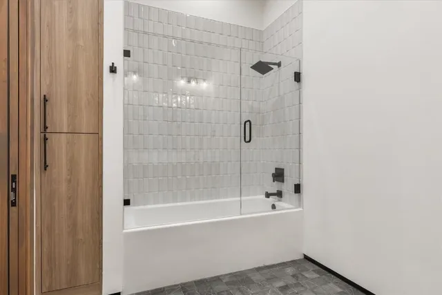 a bathroom with a bathtub and shower