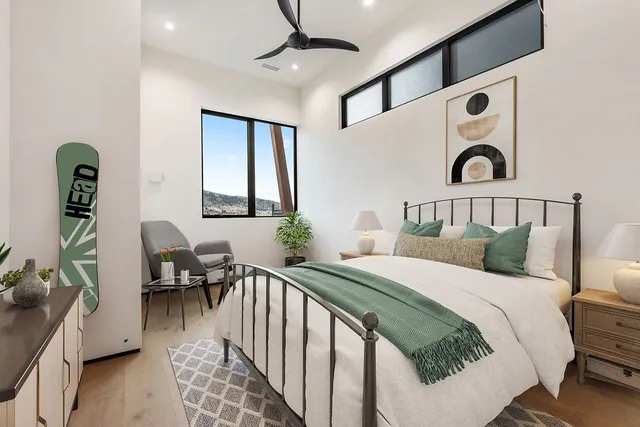 a bedroom with bed and a window