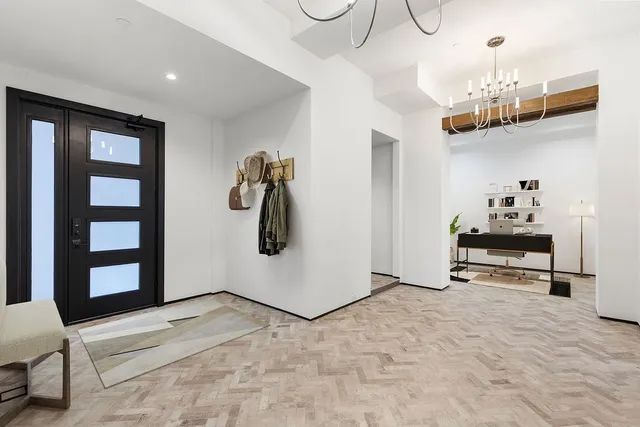 a view of a livingroom with furniture and chandelier