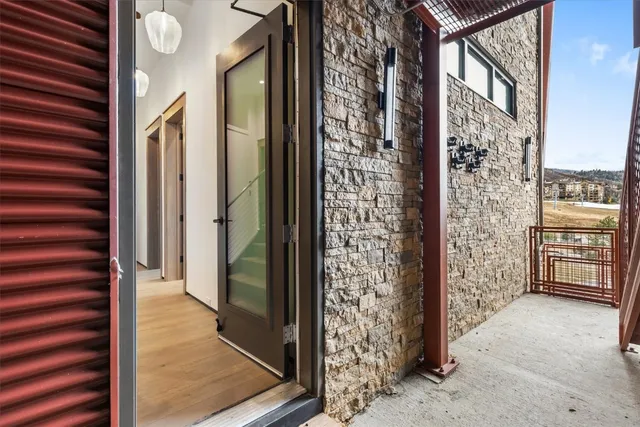 a view of a hallway with windows and stairs