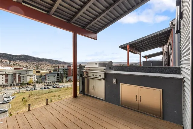 a kitchen with stainless steel appliances granite countertop a stove and a wooden floors