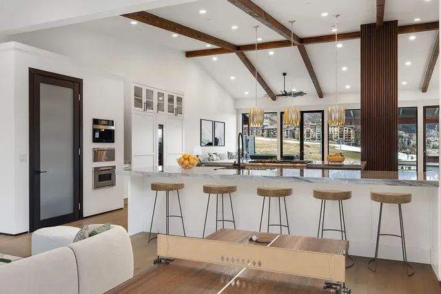a kitchen with lots of counter top space and painting on the wall