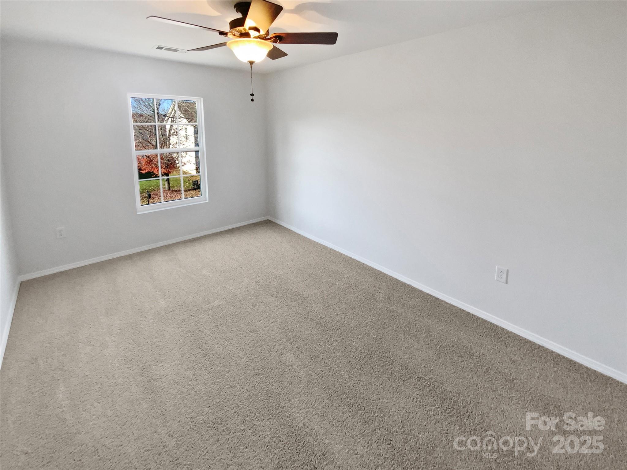 4418 Kiddle Lane Monroe, NC 28110 - Photo 11 of 19 an empty room with windows and fan