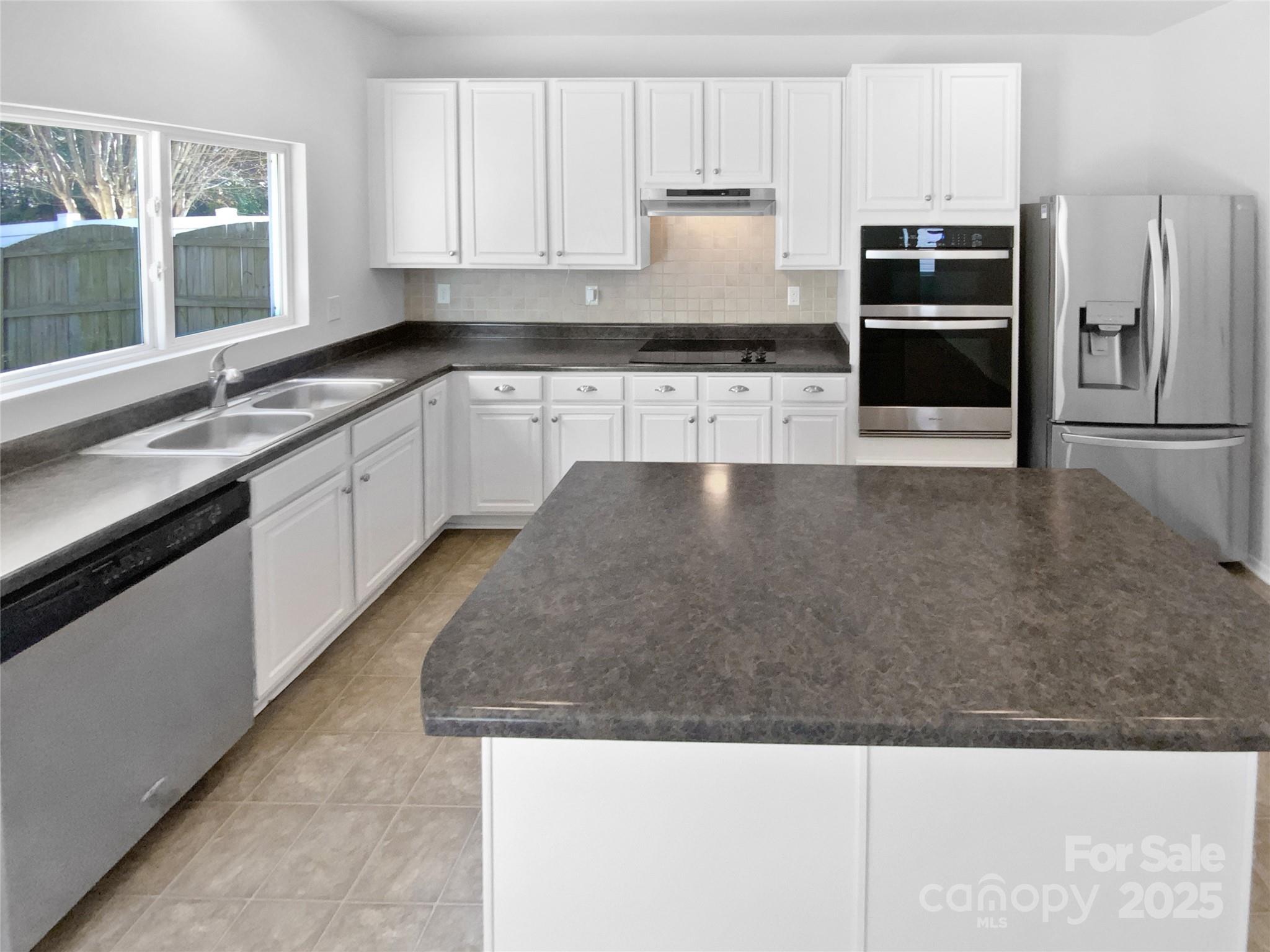4418 Kiddle Lane Monroe, NC 28110 - Photo 2 of 19 a large kitchen with cabinets