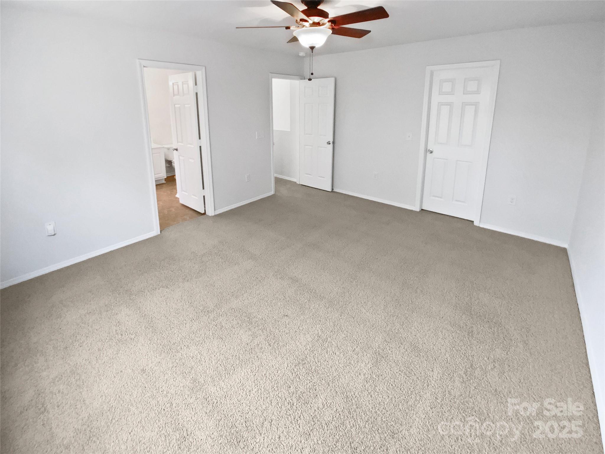 4418 Kiddle Lane Monroe, NC 28110 - Photo 4 of 19 an empty room with a ceiling fan and a window
