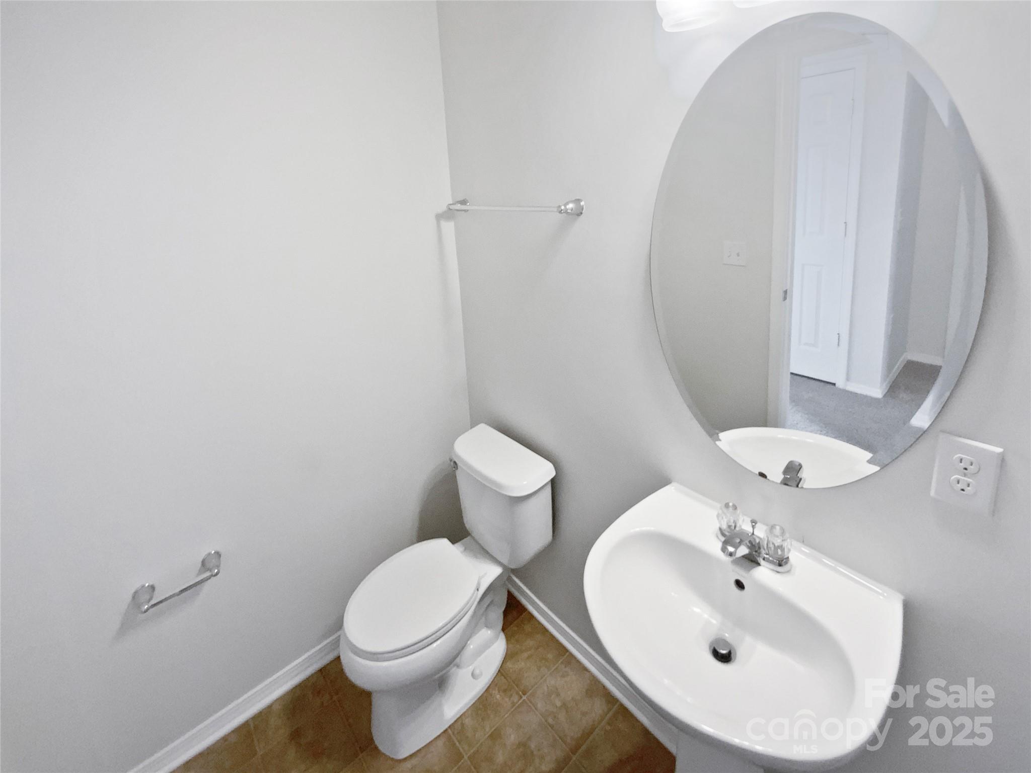 4418 Kiddle Lane Monroe, NC 28110 - Photo 9 of 19 a bathroom with a sink mirror and toilet