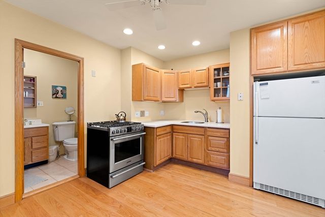 a kitchen with stainless steel appliances granite countertop a stove a sink and a refrigerator