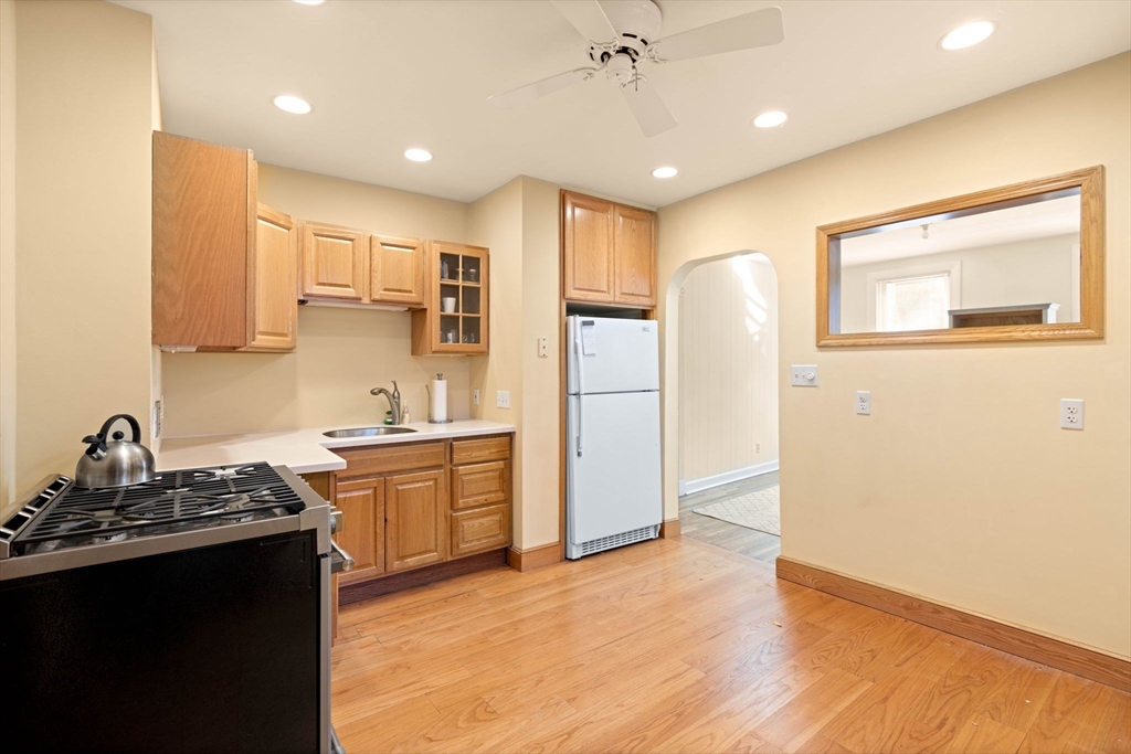 59 7th Street Cambridge, MA 02141 - Photo 14 of 26 a kitchen with kitchen island a sink stainless steel appliances and cabinets