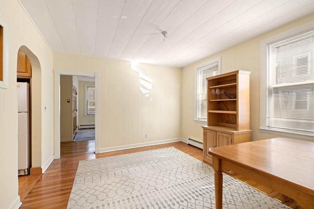 59 7th Street Cambridge, MA 02141 - Photo 17 of 26 a view of empty room with a window and wooden floor