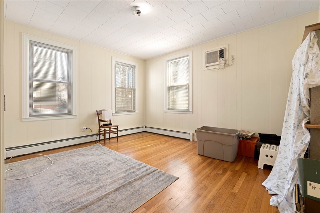 59 7th Street Cambridge, MA 02141 - Photo 20 of 26 a living room with furniture rug and a window