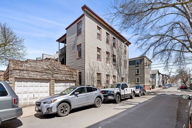 a view of a cars park in front of a building