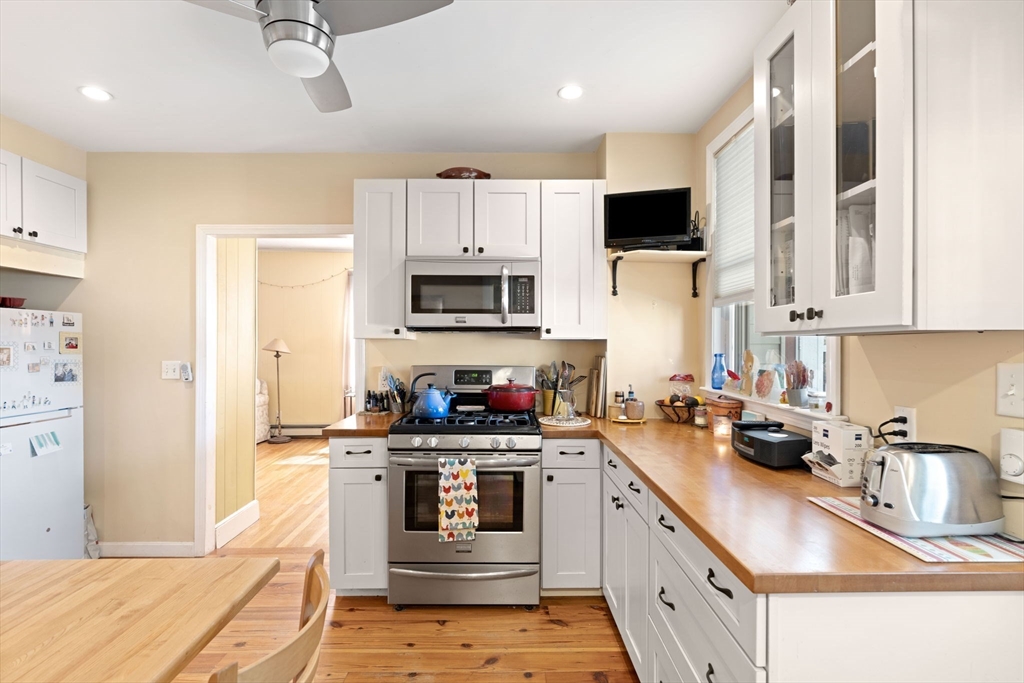 59 7th Street Cambridge, MA 02141 - Photo 4 of 26 a kitchen with stainless steel appliances a stove sink microwave and cabinets