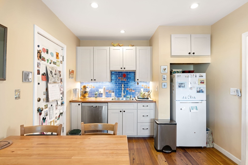 59 7th Street Cambridge, MA 02141 - Photo 6 of 26 a kitchen with stainless steel appliances granite countertop a refrigerator and a stove top oven