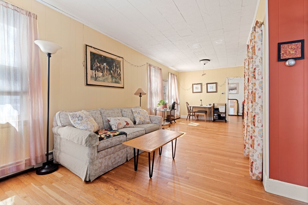 59 7th Street Cambridge, MA 02141 - Photo 10 of 26 a living room with furniture and a wooden floor