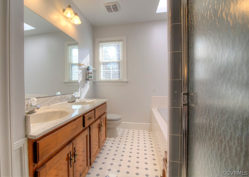 6321 Glebe Point Road Chesterfield, VA 23838 - Photo 13 of 23 a bathroom with a sink a toilet and shower