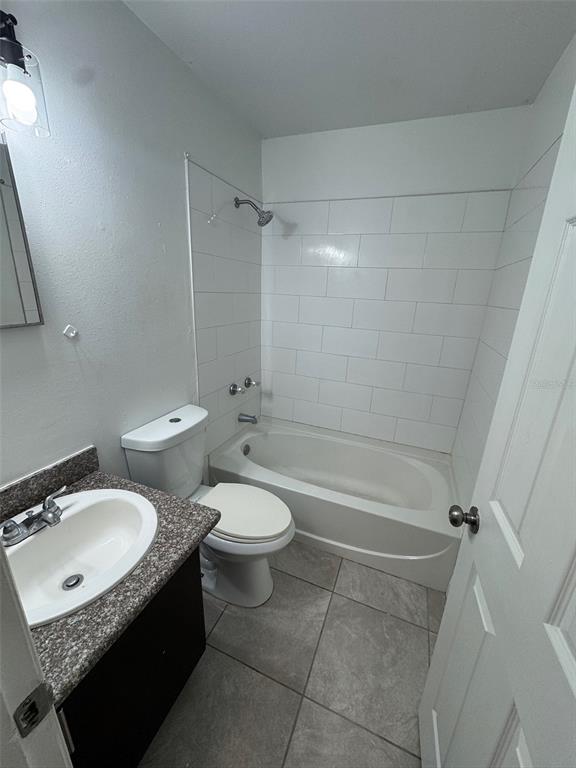 1197 Bentley Road, Unit 3 Leesburg, FL 34748 - Photo 11 of 13 a bathroom with a granite countertop sink toilet and shower