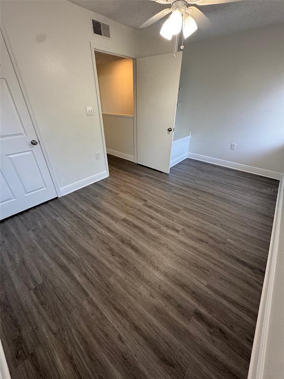 1197 Bentley Road, Unit 3 Leesburg, FL 34748 - Photo 13 of 13 an empty room with wooden floor cabinet and windows