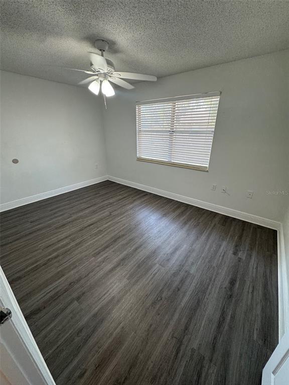 1197 Bentley Road, Unit 3 Leesburg, FL 34748 - Photo 9 of 13 wooden floor in an empty room with a window