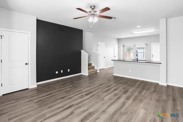 a view of a kitchen with a sink and a refrigerator