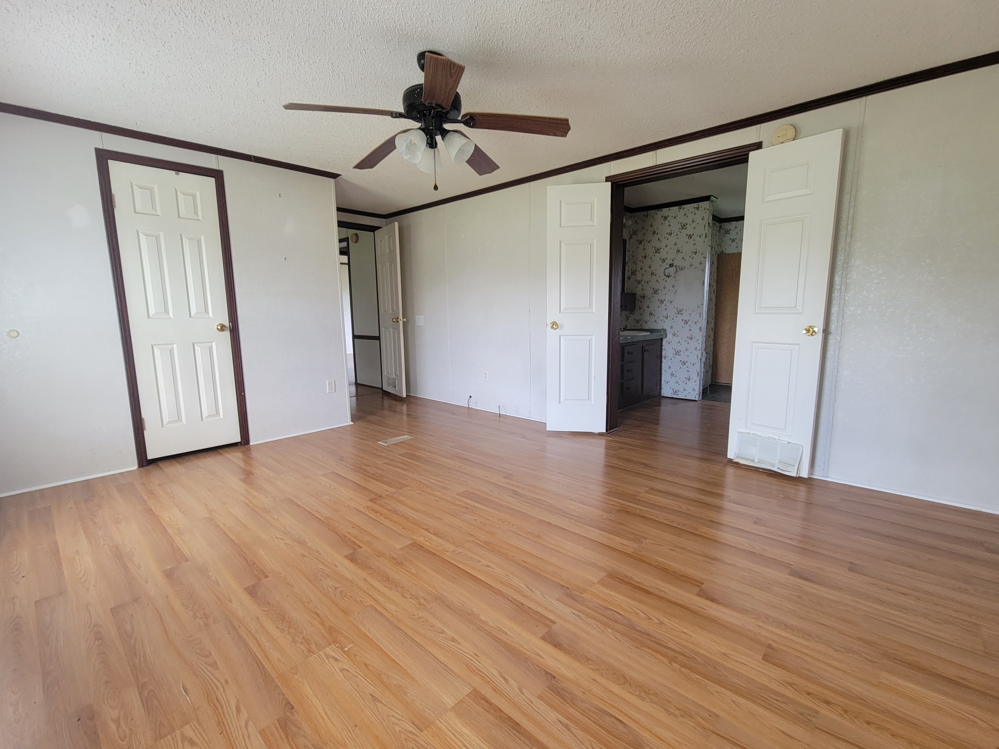 4949 Kedron Road Columbia, TN 38401 - Photo 8 of 16 a view of a livingroom with wooden floor and a ceiling fan