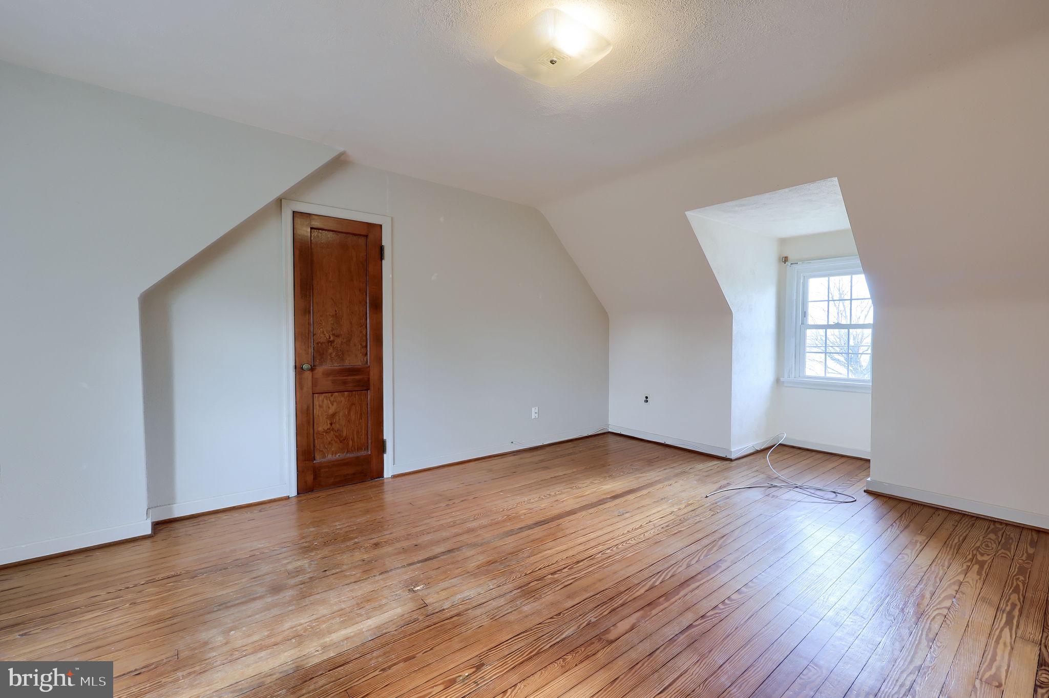 328 West Maple Street Dallastown, PA 17313 - Photo 11 of 37 an empty room with wooden floor and windows