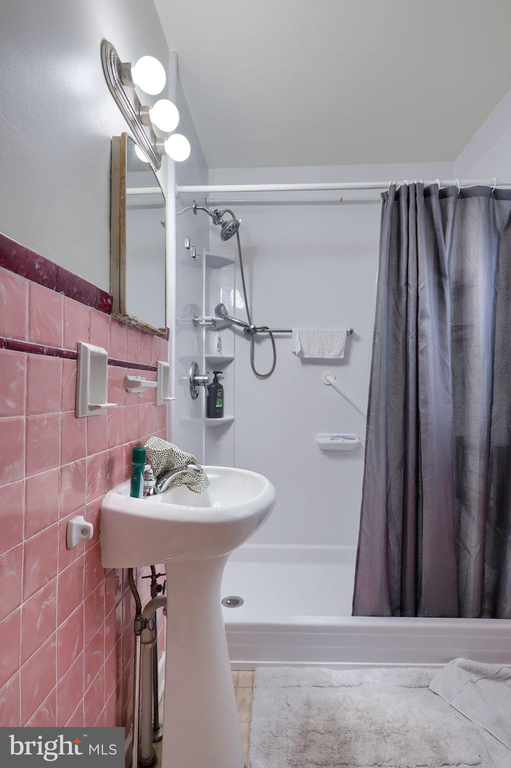 328 West Maple Street Dallastown, PA 17313 - Photo 12 of 37 a bathroom with a sink a mirror and a shower
