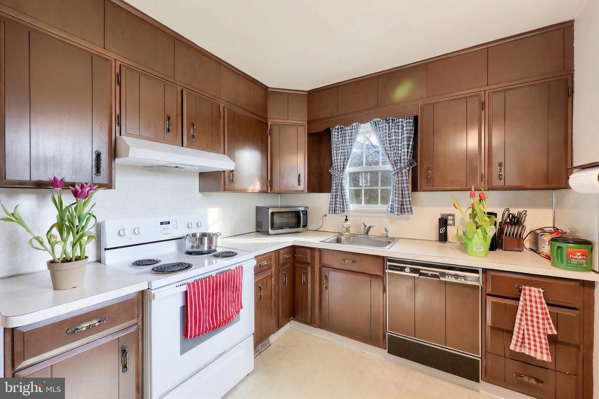 328 West Maple Street Dallastown, PA 17313 - Photo 14 of 37 a kitchen with a sink dishwasher stove and cabinets