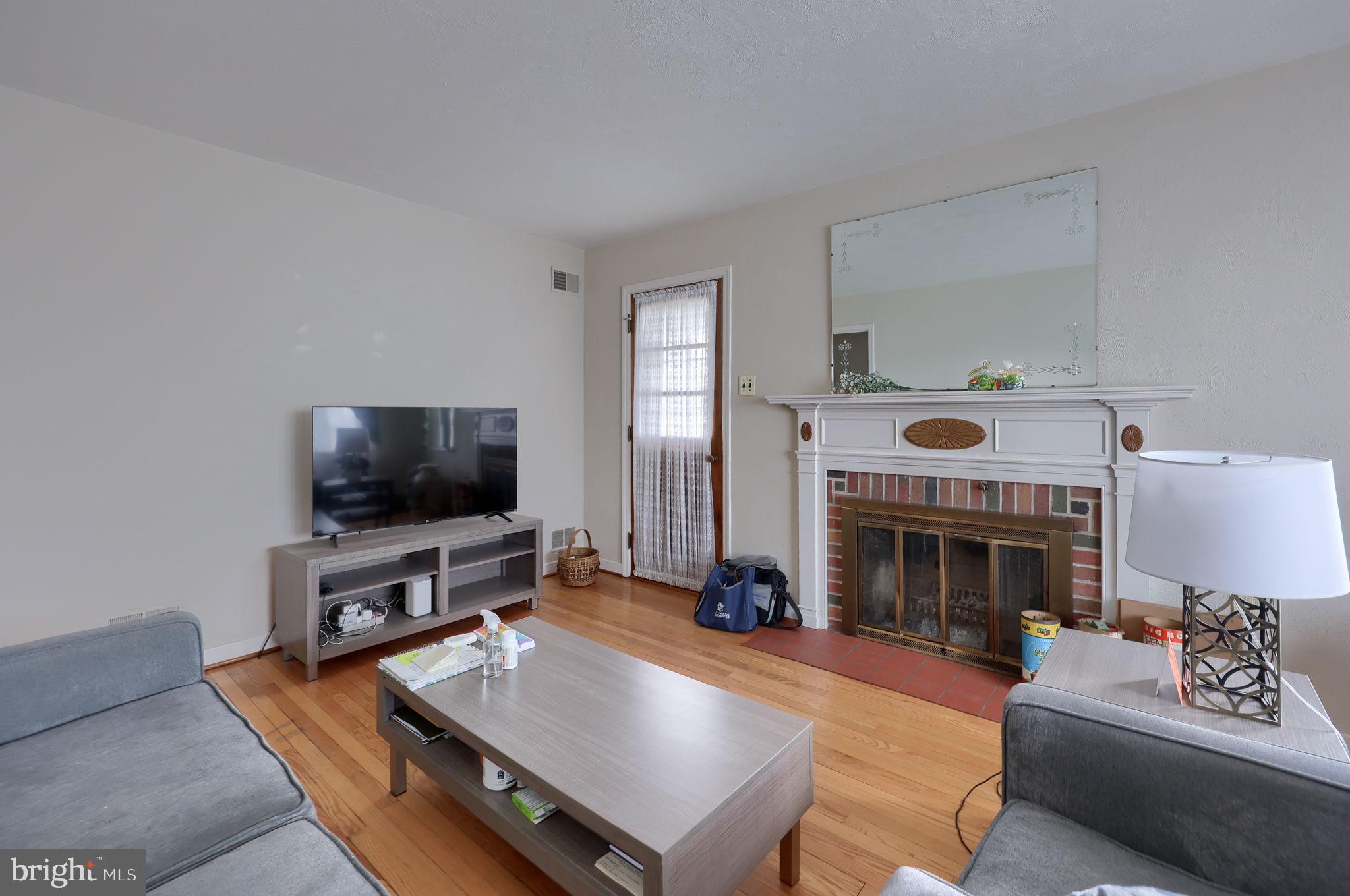 328 West Maple Street Dallastown, PA 17313 - Photo 18 of 37 a living room with furniture a fireplace and a flat screen tv