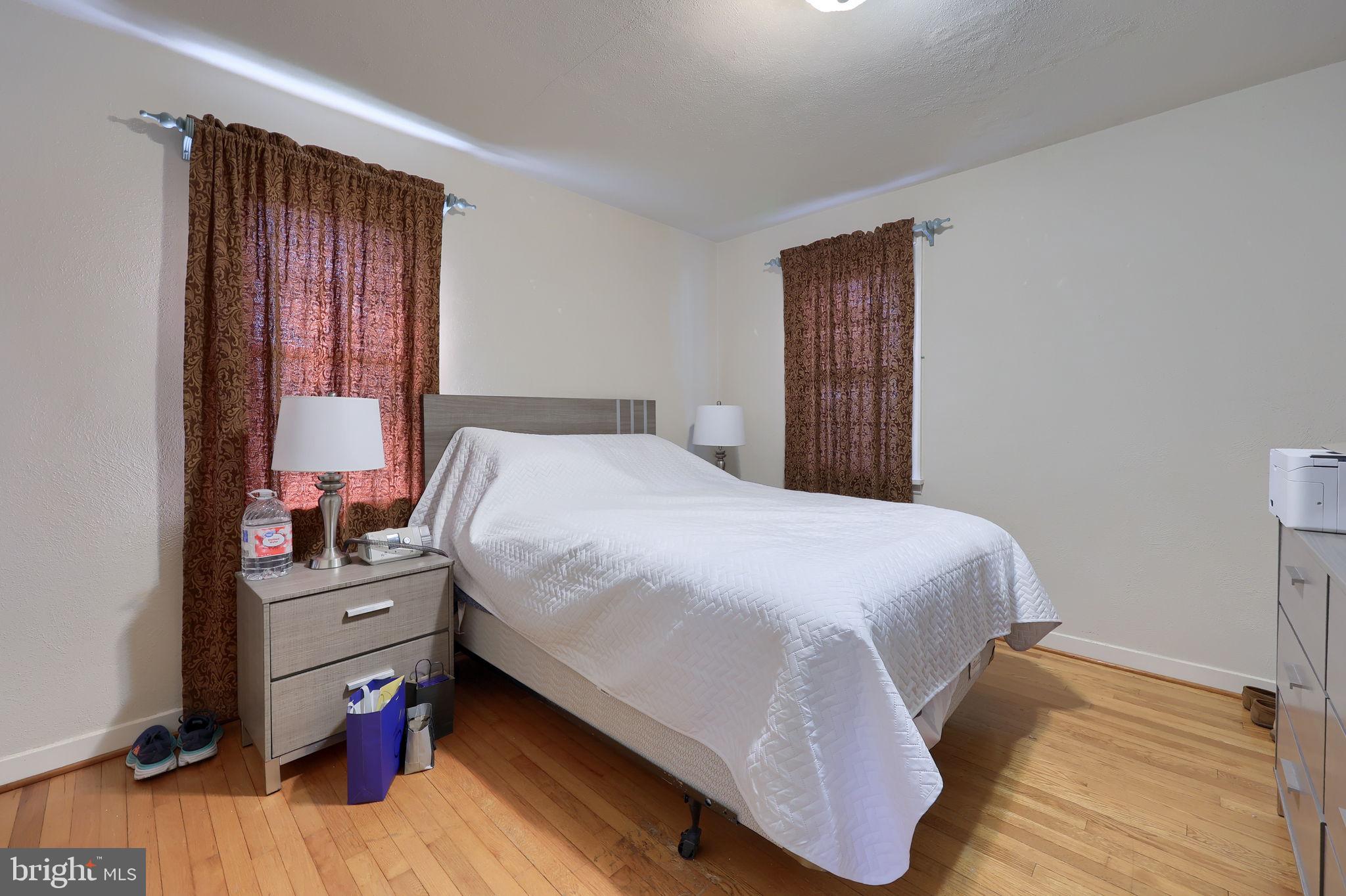 328 West Maple Street Dallastown, PA 17313 - Photo 19 of 37 a bedroom with a bed and wooden floor