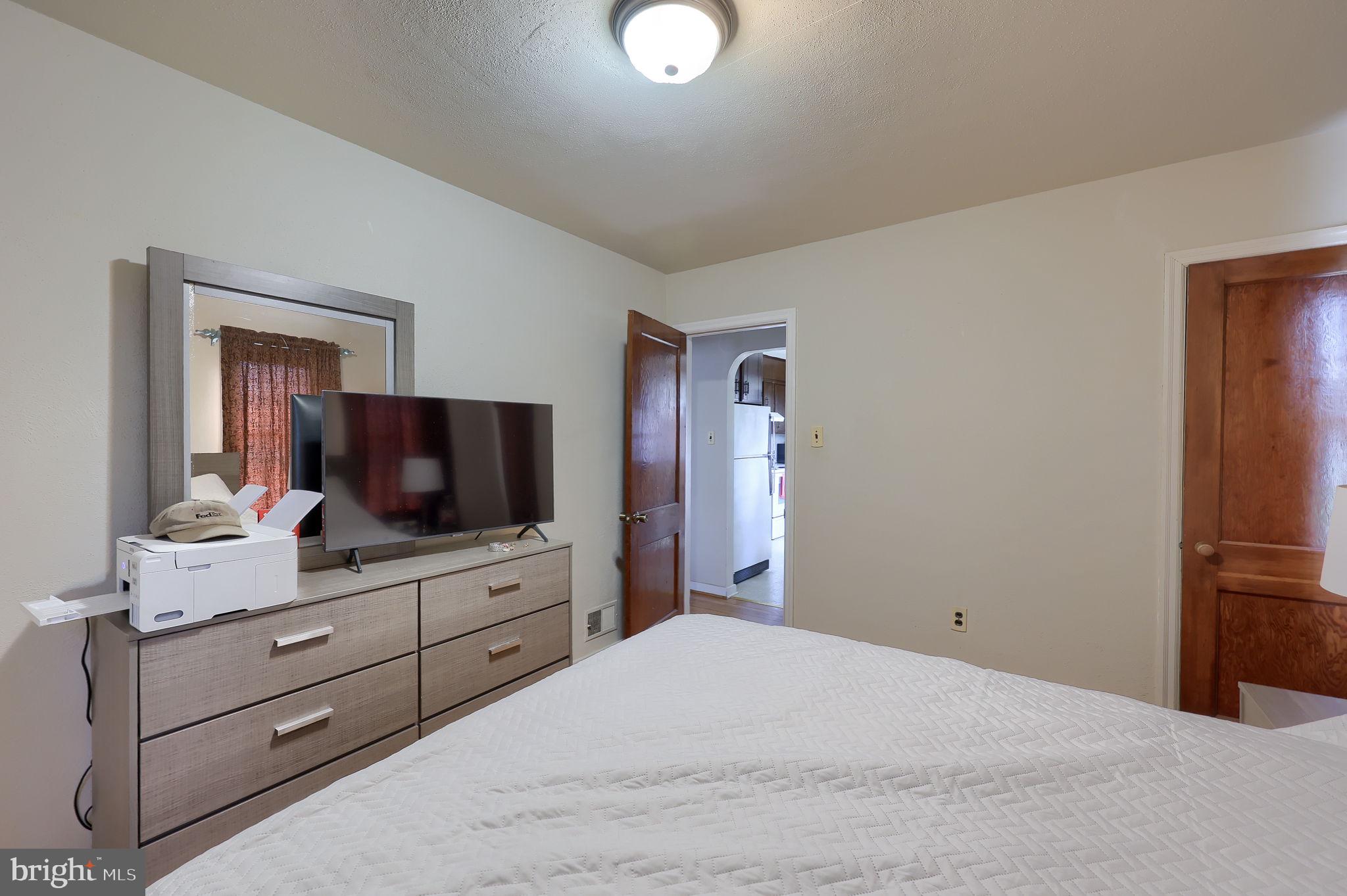 328 West Maple Street Dallastown, PA 17313 - Photo 20 of 37 a bedroom with a bed and a flat screen tv