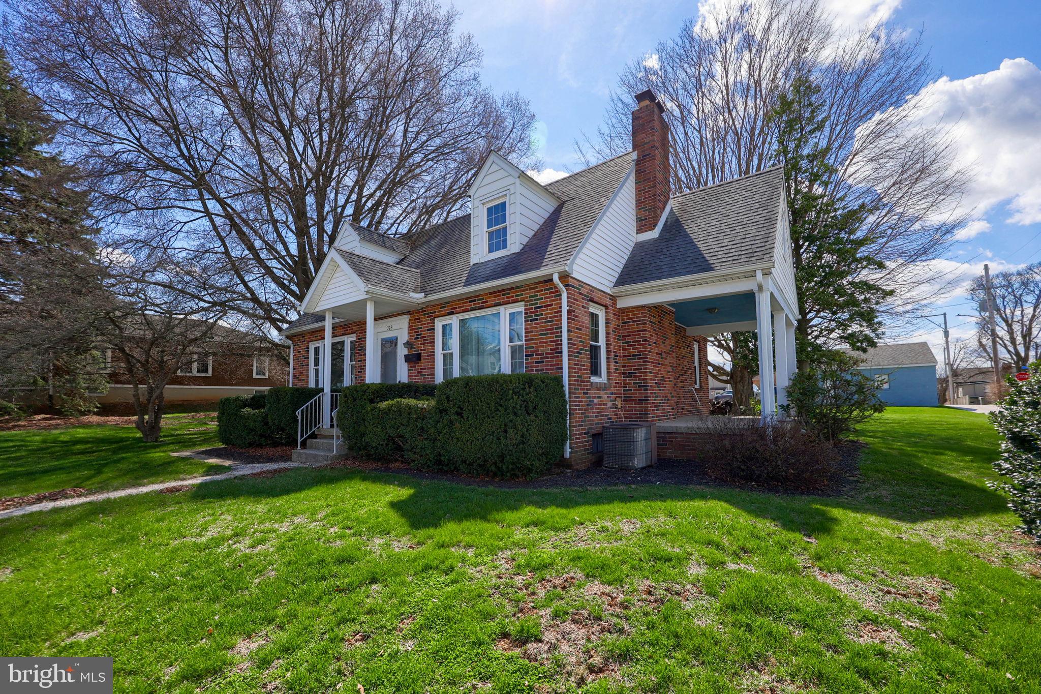 328 West Maple Street Dallastown, PA 17313 - Photo 28 of 37 a view of a brick house with a yard and plants