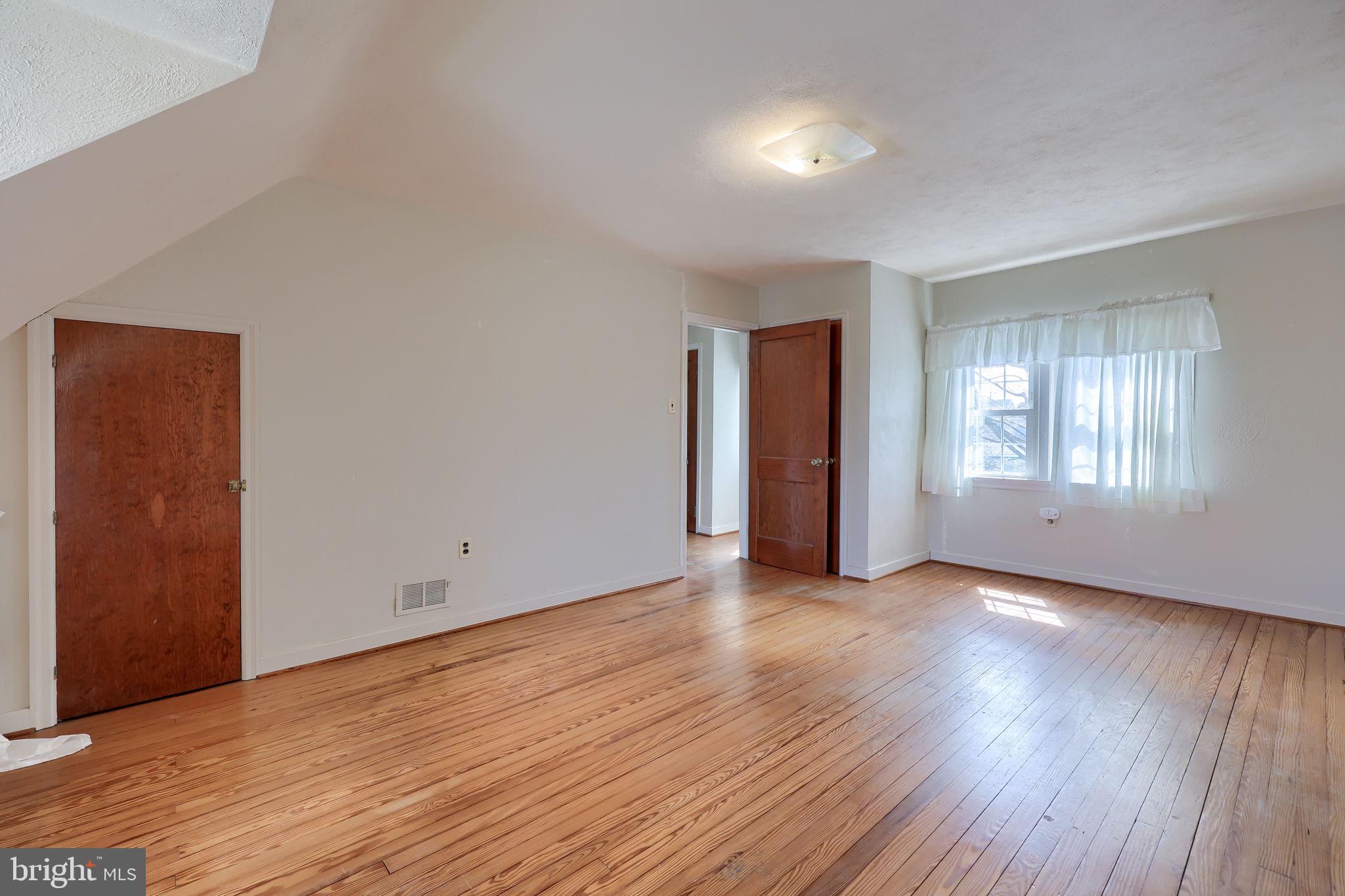 328 West Maple Street Dallastown, PA 17313 - Photo 8 of 37 an empty room with wooden floor and windows