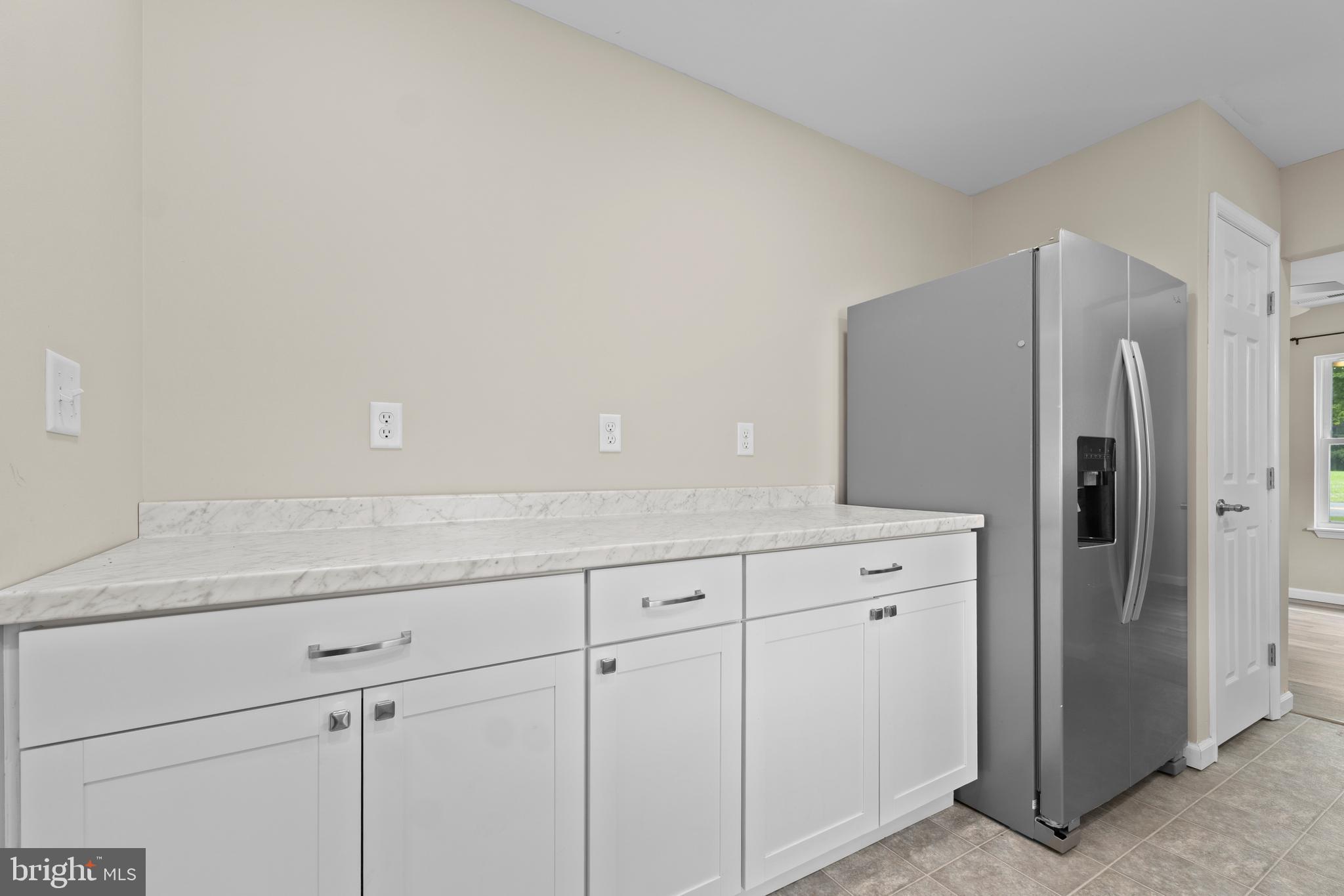 6475 Big Stone Beach Road Milford, DE 19963 - Photo 10 of 52 a kitchen with cabinets and stainless steel appliances