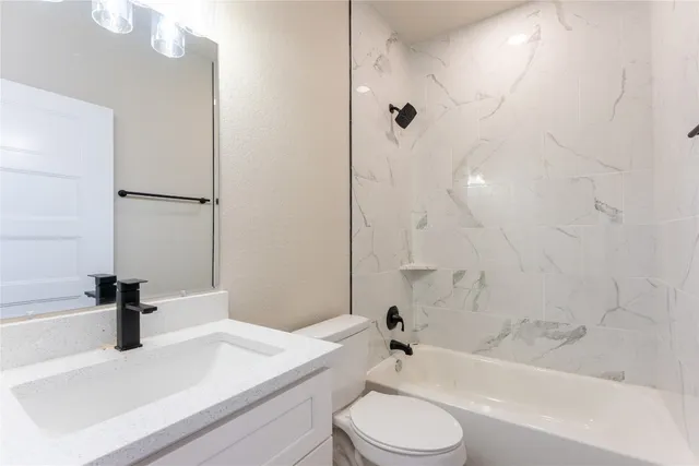 a bathroom with a sink a toilet and a bathtub