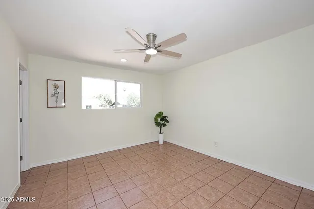 a view of a big room with chandelier fan and windows