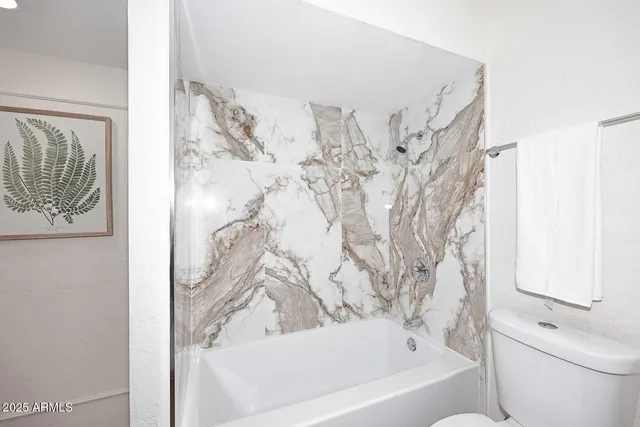 a bathroom with a bathtub and shower