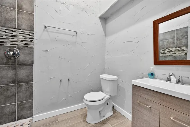 a bathroom with a toilet a sink and a shower