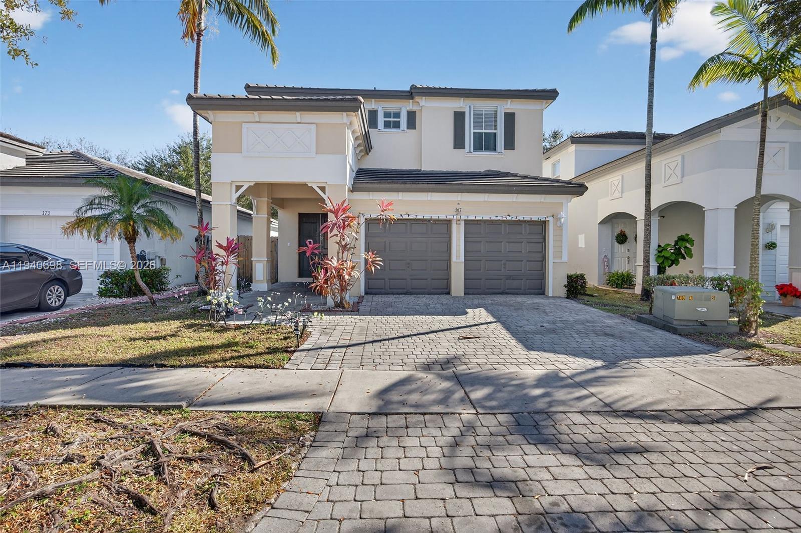 367 Northeast 36th Avenue Road Homestead, FL 33033 - Photo 1 of 36 a front view of a house with a yard and potted plants