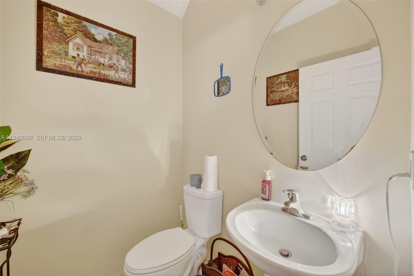 367 Northeast 36th Avenue Road Homestead, FL 33033 - Photo 13 of 36 a bathroom with a toilet sink and mirror