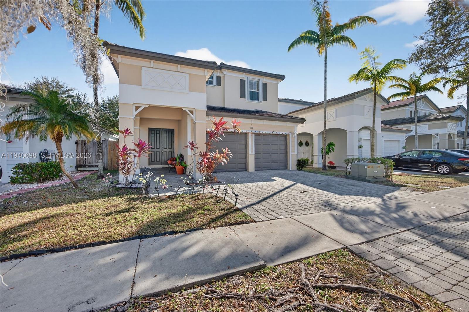 367 Northeast 36th Avenue Road Homestead, FL 33033 - Photo 2 of 36 a front view of a house with garage and outdoor seating