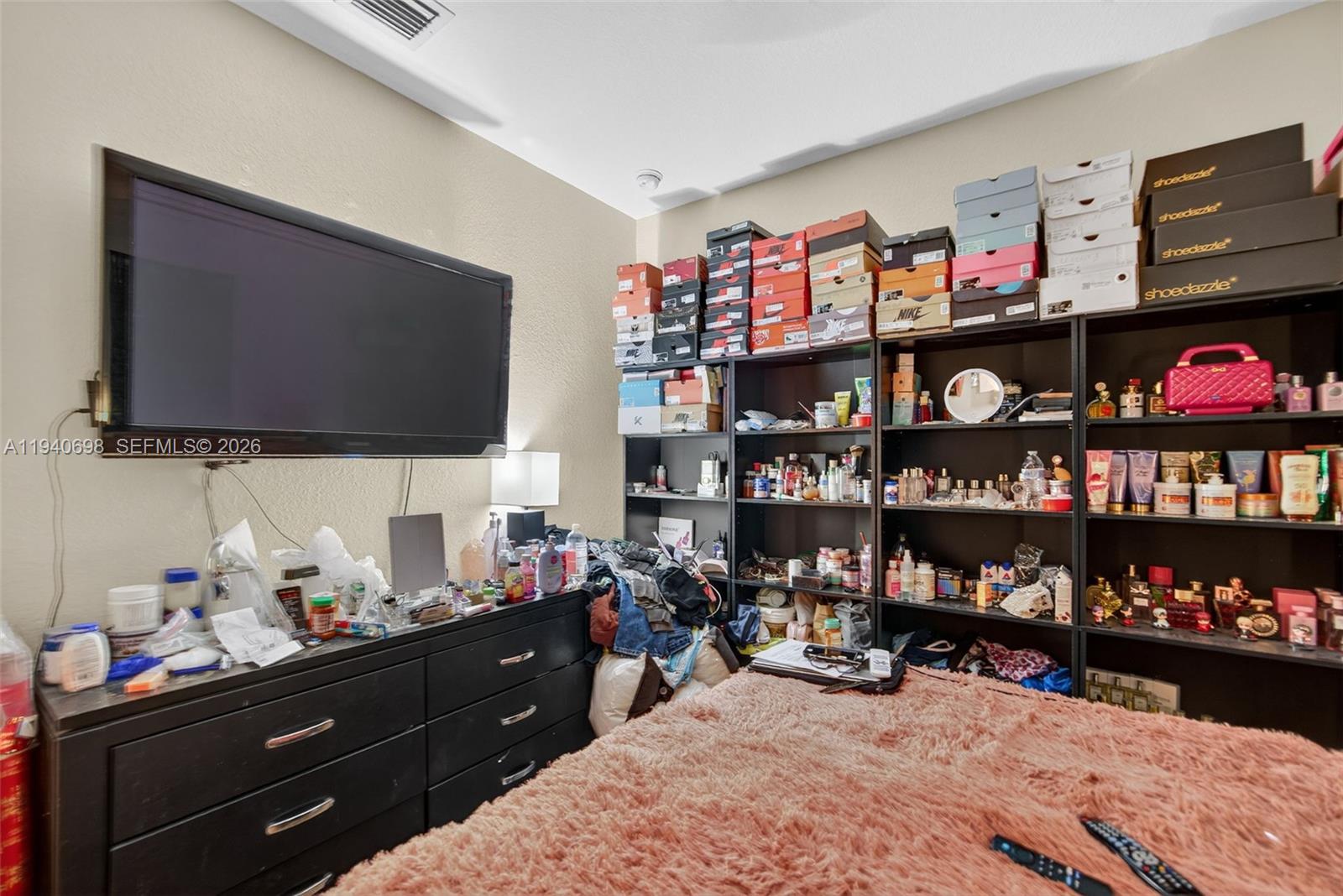 367 Northeast 36th Avenue Road Homestead, FL 33033 - Photo 23 of 36 a room with lots of books and a flat screen tv