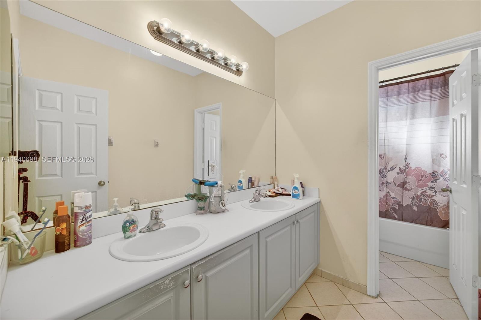 367 Northeast 36th Avenue Road Homestead, FL 33033 - Photo 25 of 36 a bathroom with a double vanity sink and a mirror