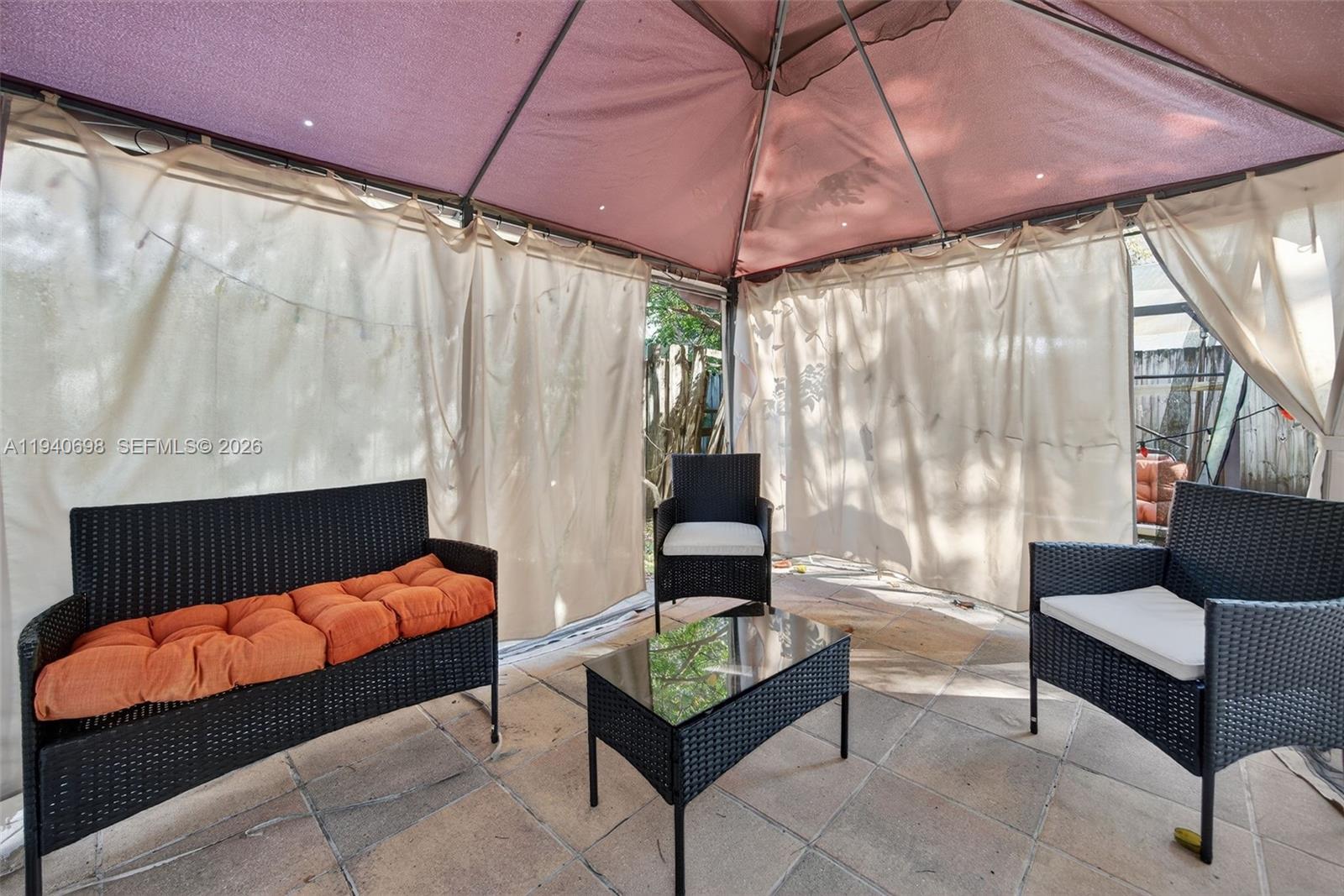 367 Northeast 36th Avenue Road Homestead, FL 33033 - Photo 31 of 36 a outdoor living space with furniture and a umbrella